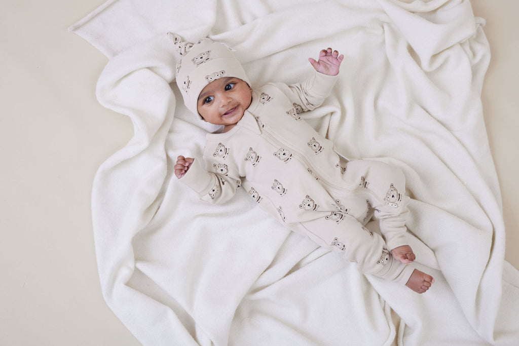 Baby wearing Aster & Oak Organic Zip Romper – Byron Bear Onesie