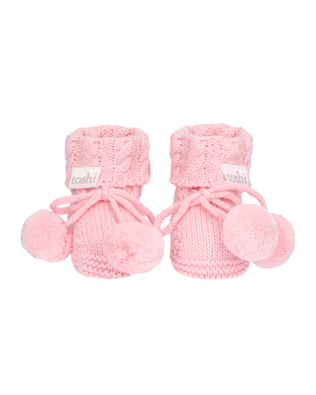 Misty Rose, a Pink knitted baby booties with pom-poms on a white background