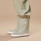Crywolf Rain Boots Moss with sage green rain pants on a beige background.
