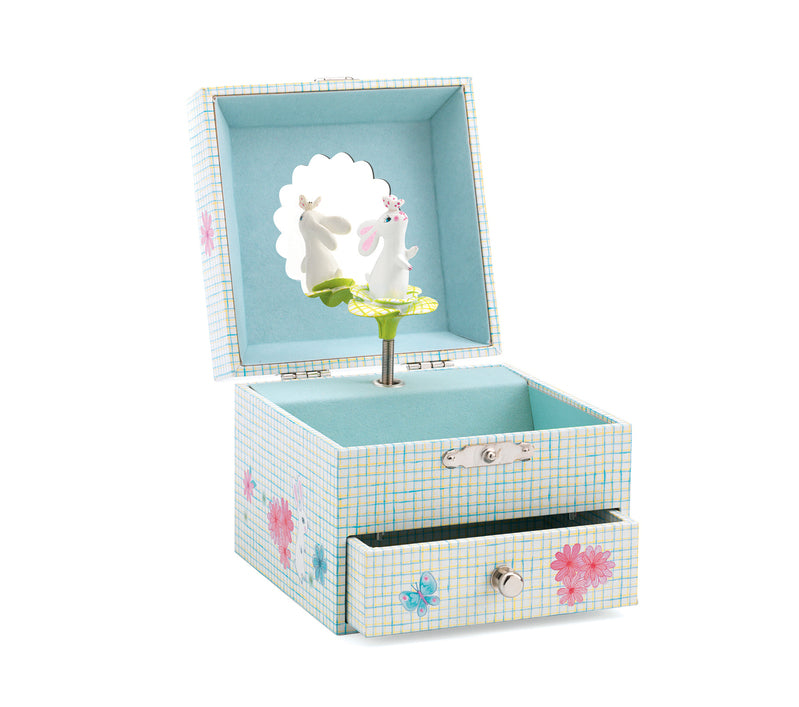 Music Box Sweet Rabbits Song , a Light blue and yellow crosshatch-patterned musical jewelry box featuring a spinning white bunny figurine, a scalloped mirror, a soft blue interior lining, and pink floral accents on a pull-out bottom drawer.