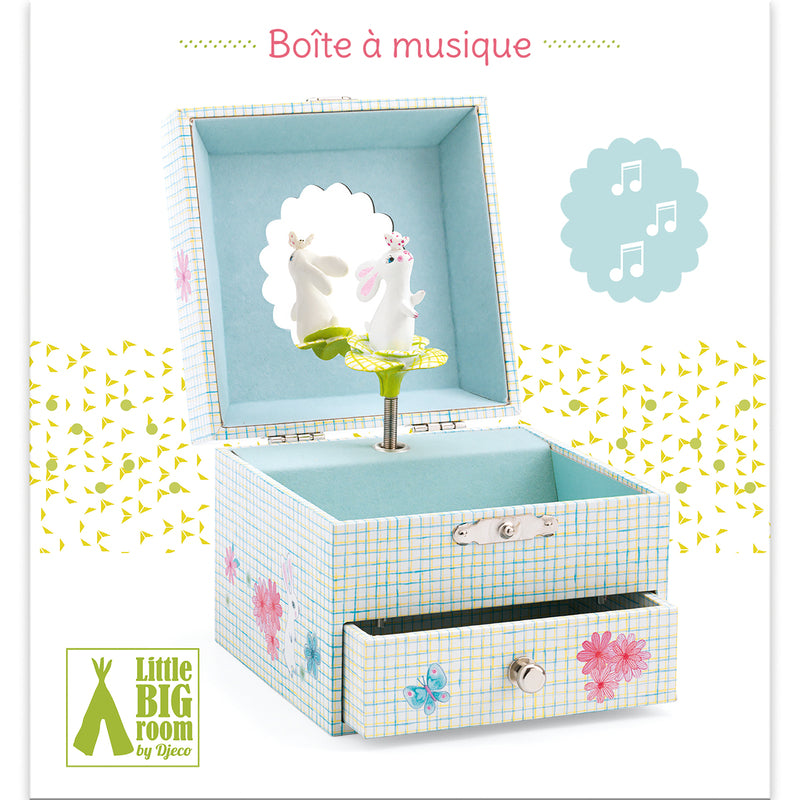 Music Box Sweet Rabbits Song , a Light blue and yellow crosshatch-patterned musical jewelry box featuring a spinning white bunny figurine, a scalloped mirror, a soft blue interior lining, and pink floral accents on a pull-out bottom drawer.