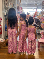 Three young girls wearing Lilac haze print, bohemian-style in vibrant shades of magenta, pink, and cream.