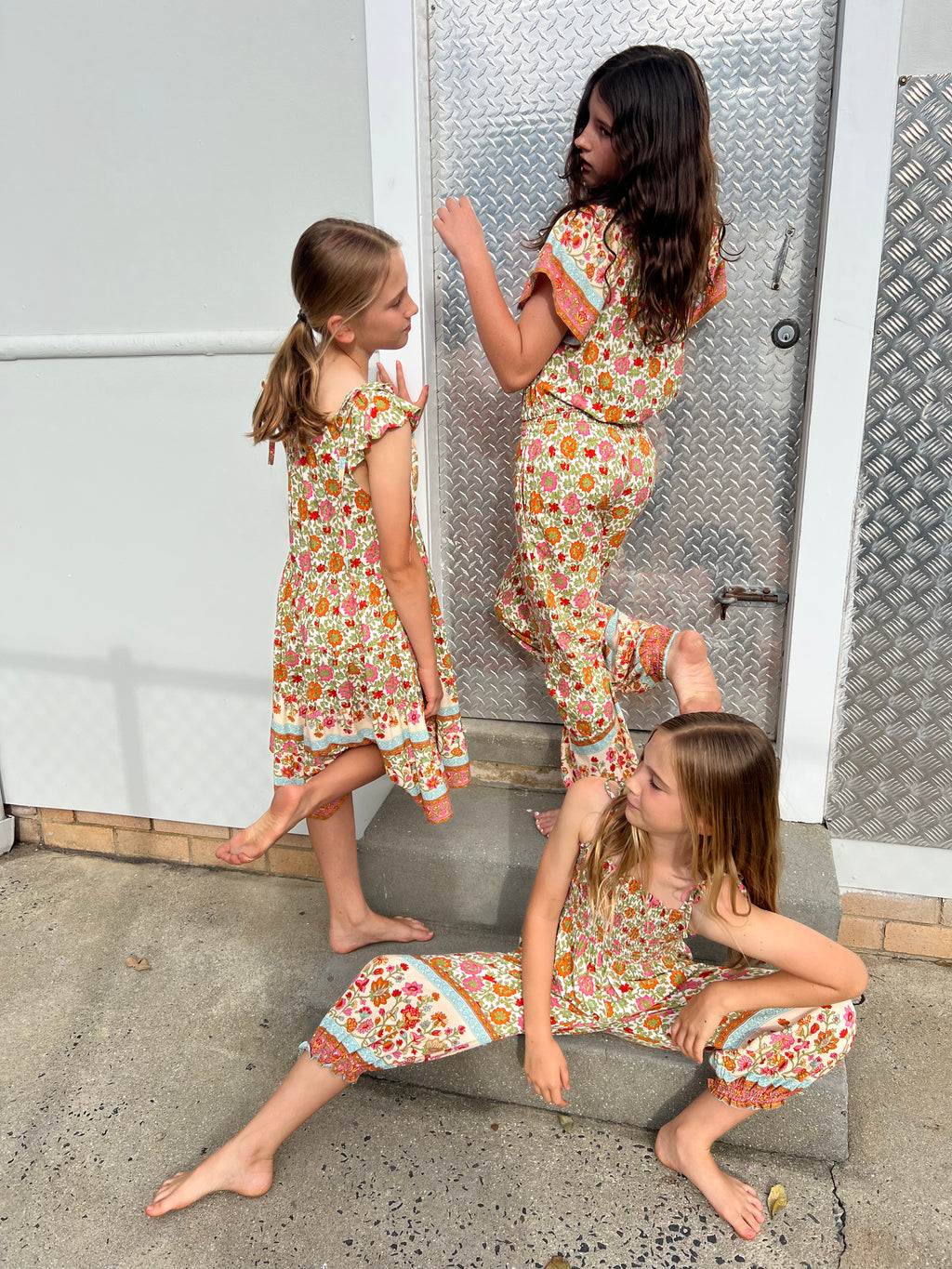 Three young girls in MilaMeli Festival Garden print clothes.