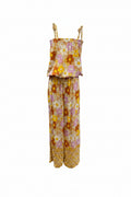 Sleeveless bohemian-style kids' jumpsuit showcasing Sun Daisy print, a vintage floral pattern in mustard yellow, rust orange, and dusty pink. Featuring a smocked elastic top, adjustable shoulder ties, and wide-leg trousers.