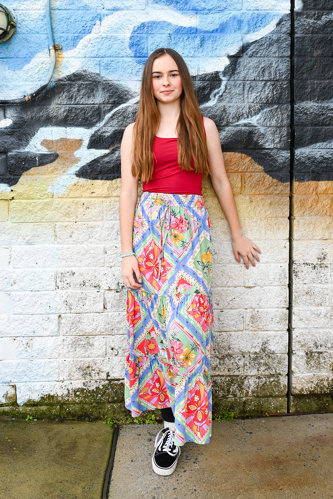A young woman with long brown hair waearing aeve Maxi Skirt Butterfly Patch Print.