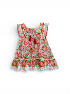 Floral dress featuring Fiesta Bloom print, a white base with a vibrant floral pattern in red, orange, green, and blue.