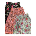 Three pairs of women's tiered ruffle shorts with floral prints, stacked diagonally. The top is Maeve Maxi Skirt Indigo Wildflower and the middle is the Maeve Maxi Skirt blush pink print, the bottom is Maeve Maxi Skirt Indigo Wildflower Print.