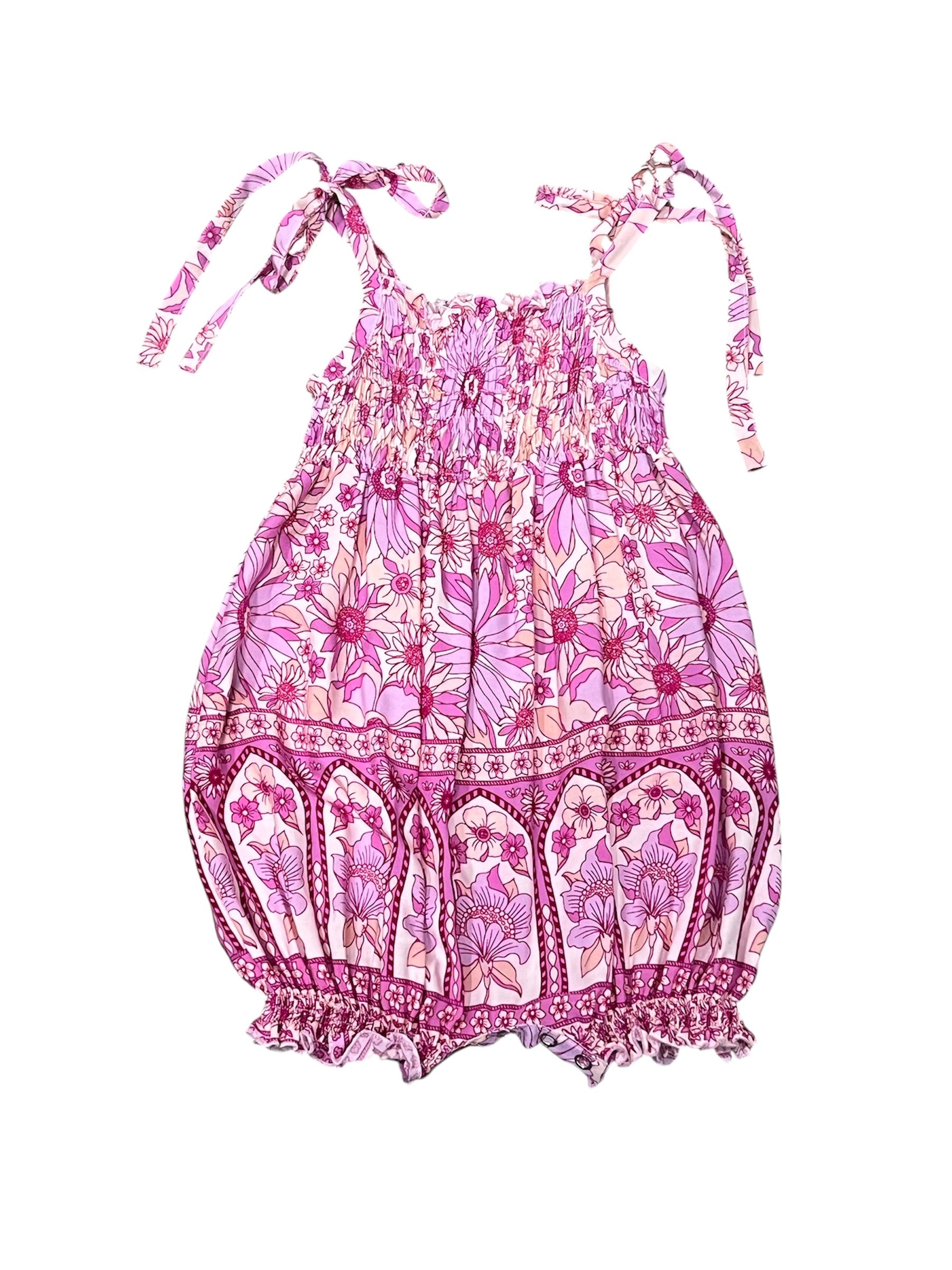 Pink floral print baby romper with tie-shoulder straps and a smocked bodice, shown flat on a white background.
