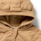 Close-up of Wilson & Frenchy Honey Fawn Organic Quilted Jacket, a Beighe quilted with bear ears.