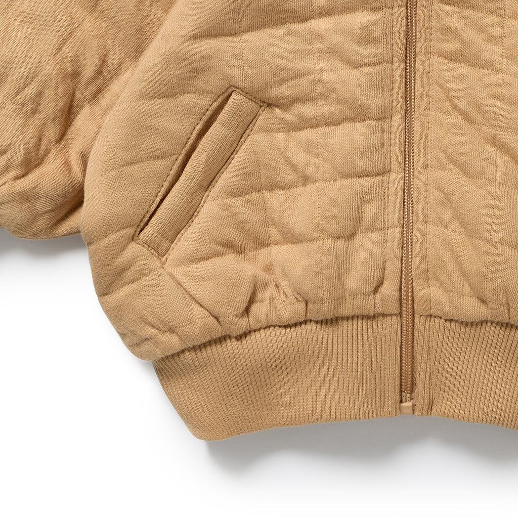 Close-up of Wilson & Frenchy Honey Fawn Organic Quilted Jacket, a Beighe quilted with bear ears.