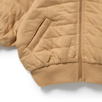 Close-up of Wilson & Frenchy Honey Fawn Organic Quilted Jacket, a Beighe quilted with bear ears.