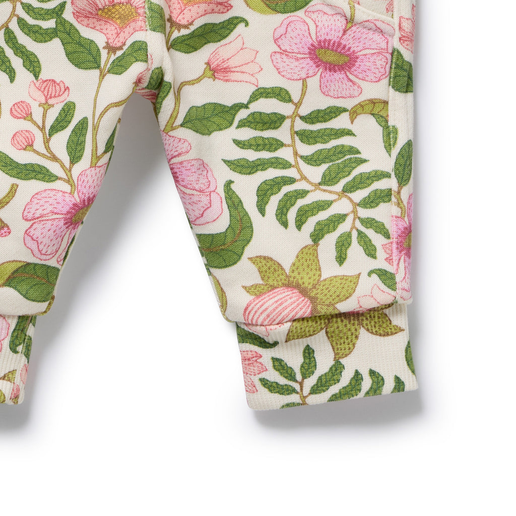 Floral patterned fabric with pink flowers and green leaves on a white background