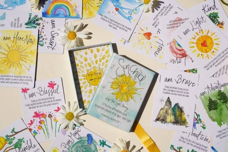 Collection of affirmation cards with motivational phrases and illustrations on a yellow background